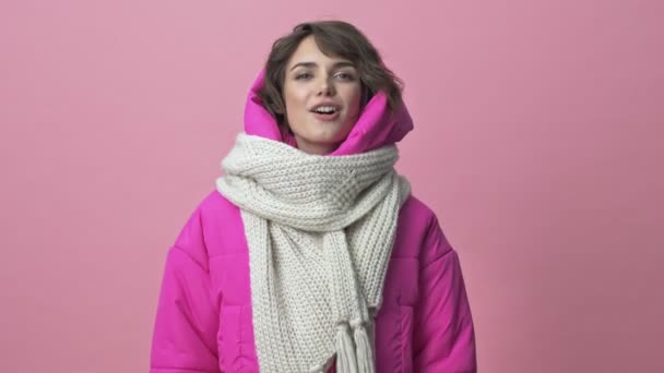 Smiling Woman Wearing Winter Jacket Scarf Talking Camera Isolated Pink — ストック動画