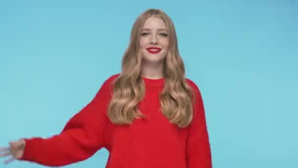 Radosna Piękna Kobieta Swetrze Pokazuje Gest Patrząc Kamerę Turkusowym Tle — Wideo stockowe