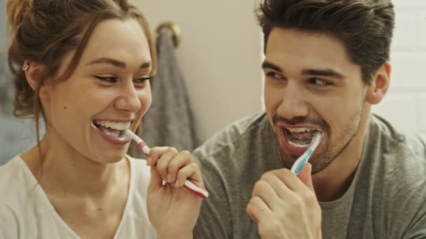 Attractive Couple Having Fun While Cleaning Teeth Together Bathroom Brush — Stock Video