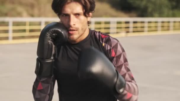 Een Sportieve Knappe Man Een Trainingspak Zwarte Handschoenen Doet Boksoefeningen — Stockvideo