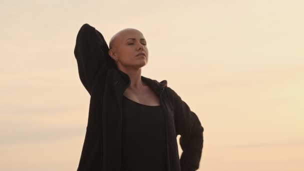 Serious Attractive Bald Sports Woman Stretching Her Hands Overhead Looking — 비디오