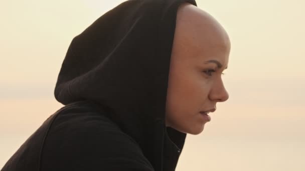 Side View Smiling Attractive Bald Sports Woman Hood Looking Away — Stock Video