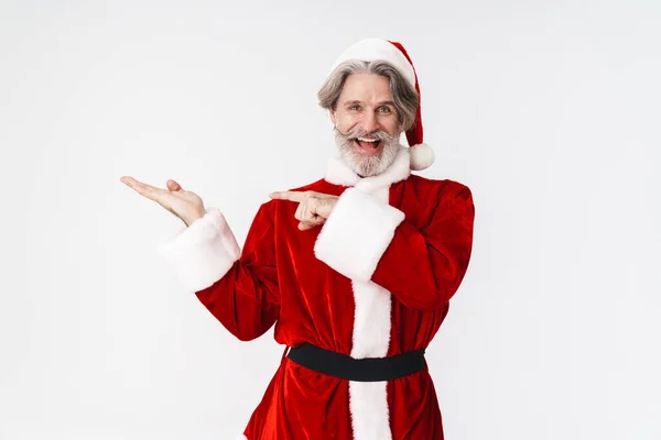 Image of Santa Claus man in red costume holding copyspace on his — Stock Photo, Image