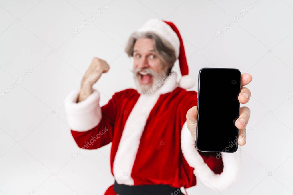 Portrait of excited old man holding cellphone and celebrating success