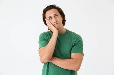 Telif alanına doğru bakan ve yanağına dokunan üzgün bir adamın görüntüsü