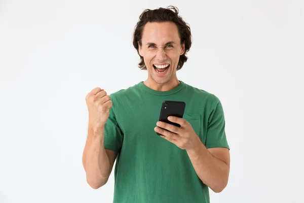 一个快乐的黑发男人一边尖叫一边拿着智能手机的图片 — 图库照片