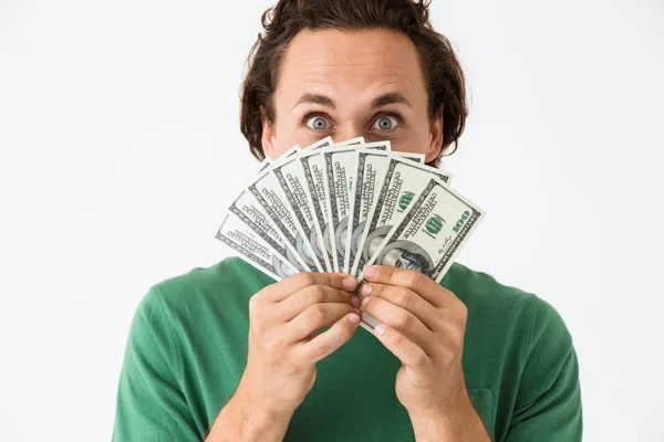 Bild av positiv brunett man täcka sitt ansikte med kontanter pengar — Stockfoto