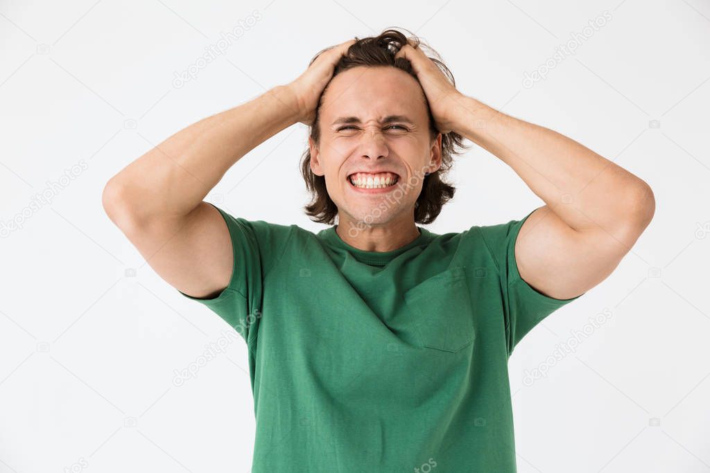 Image of delighted brunette man laughing and grabbing head