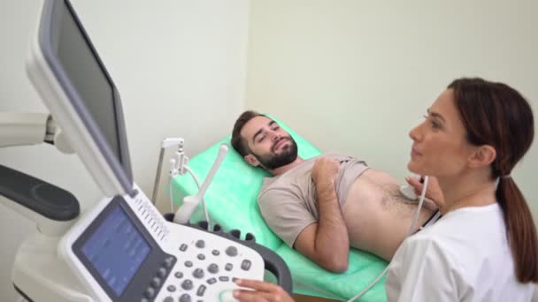 Homem Atraente Está Recebendo Ultra Som Abdominal Por Médico Feminino — Vídeo de Stock