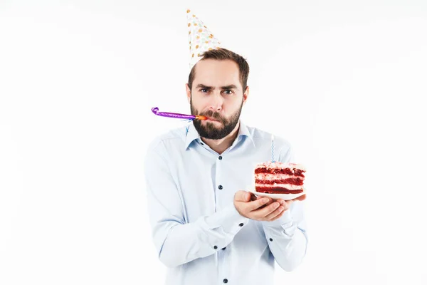 Image of optimistic man blowing party horn and holding birthday — Stock Photo, Image