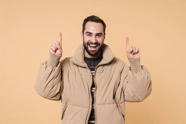 Imagen del hombre en chaqueta de invierno apuntando con los dedos hacia arriba en copyspa — Foto de Stock