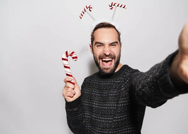 Bild av mannen i nyår pannband tar selfie med jul c — Stockfoto