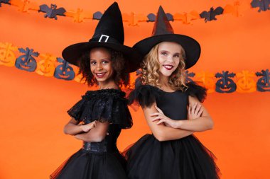 Image of nice witch girls smiling and standing together
