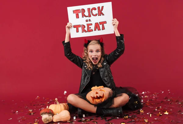 Devil in carnival halloween costume holding blank — Stockfoto