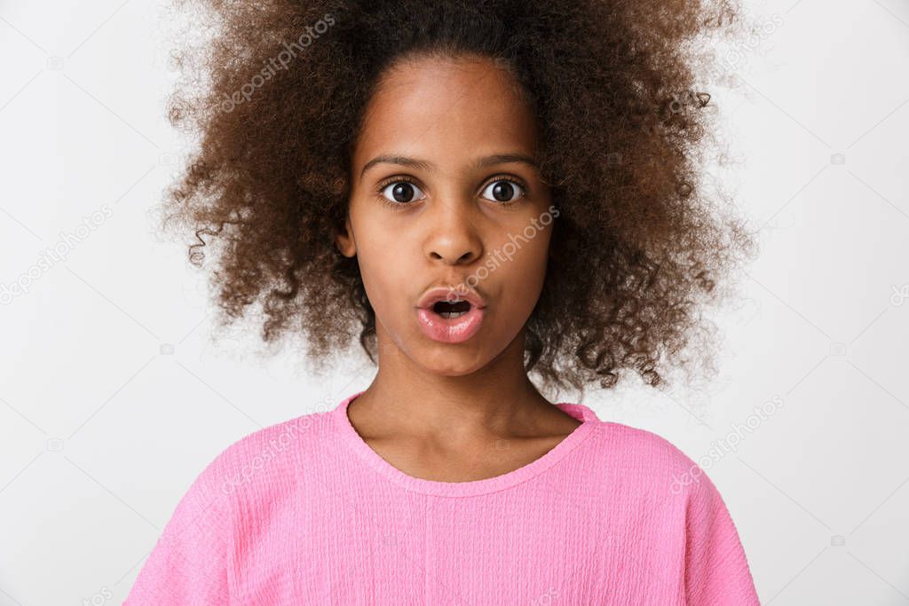 Shocked young african girl kid posing isolated