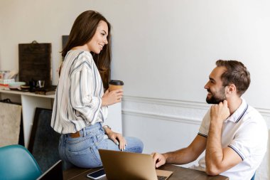 Smiling young couple working on a project