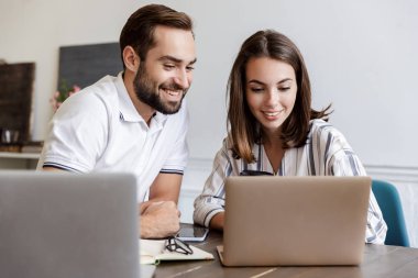 Smiling young couple working on a project