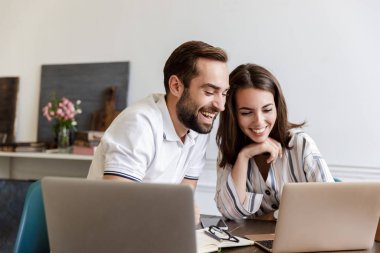 Smiling young couple working on a project