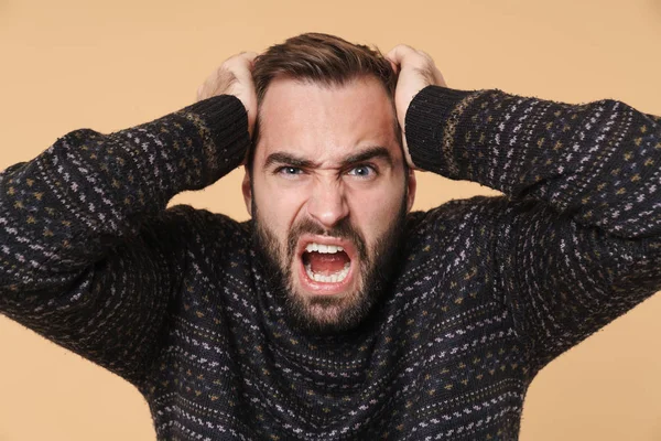 Upset young bearded man wearing warm sweater standing — Stock Photo, Image