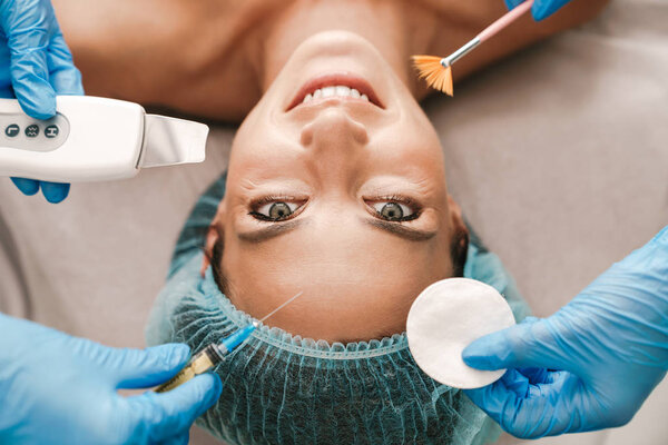 Photo closeup of happy caucasian woman getting cosmetic procedure