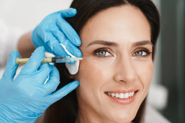 Photo of smiling woman getting mesotherapy treatment in face — Stock Photo, Image