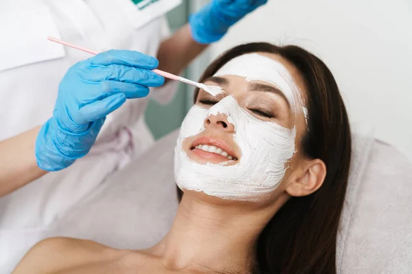 Photo of attractive smiling woman getting cosmetic procedure — 스톡 사진