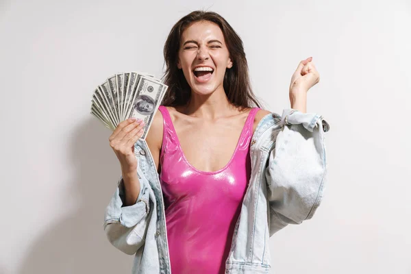 Image of happy young brunette woman holding bunch of dollar bank — Stock Photo, Image