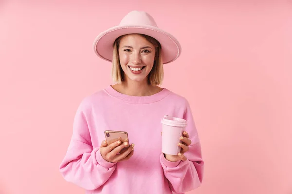 Porträt einer attraktiven Frau mit Hut und Smartphone und Kaffeetasse — Stockfoto