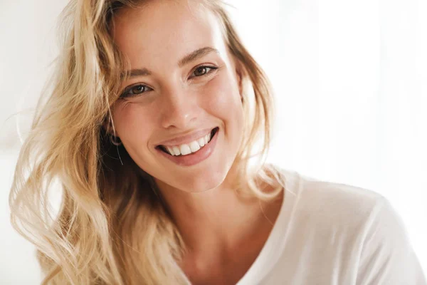 Smiling young beautiful blonde woman wearing t-shirt — Stock Photo, Image