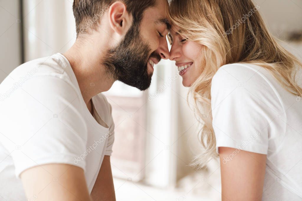 Beautiful young couple relaxing on bed