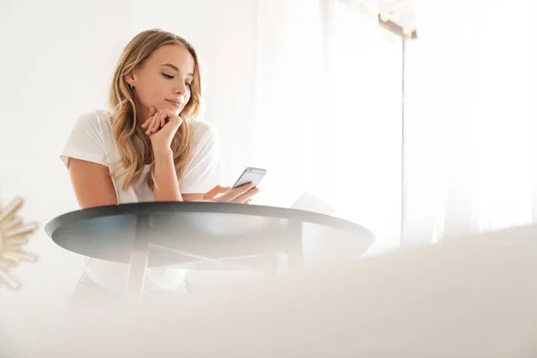 Atractiva joven sonriente mujer usando el teléfono móvil —  Fotos de Stock