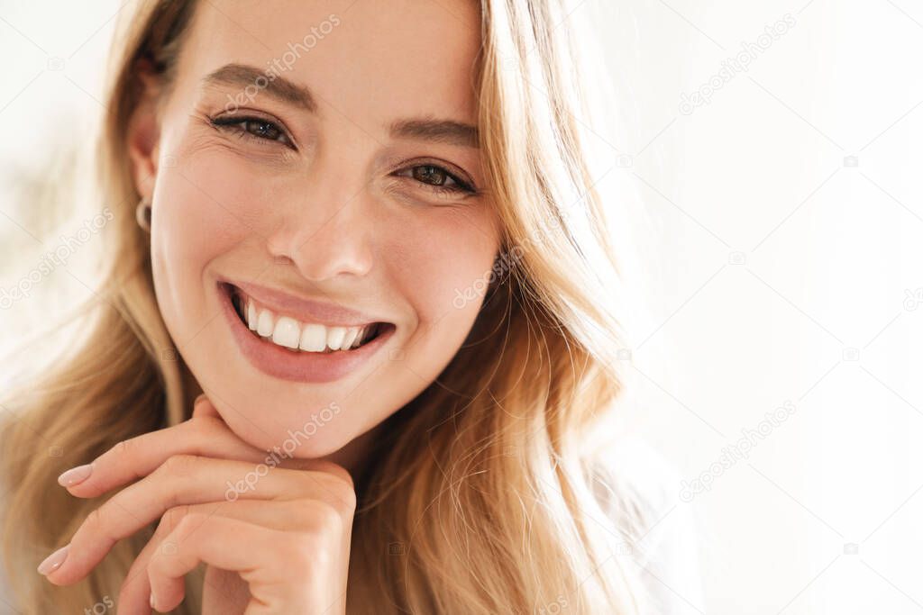 Smiling young beautiful blonde woman wearing t-shirt