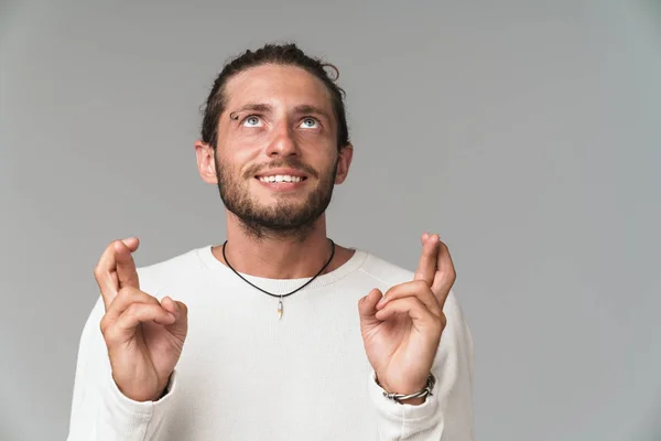 Worried young man standing isolated over gray background — Stock Photo, Image