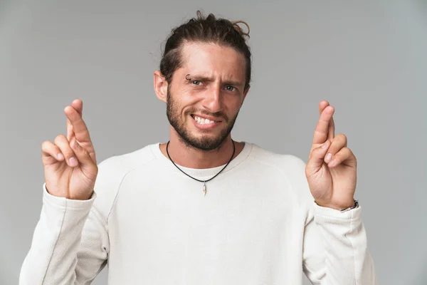 Worried young man standing isolated over gray background — Stock Photo, Image