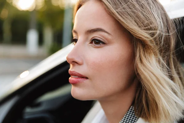 Image of young beautiful businesslike woman sitting in luxury ca — ストック写真