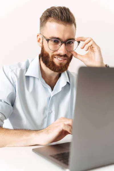 Cheery optimistic young businessman using laptop computer — Stock Photo, Image