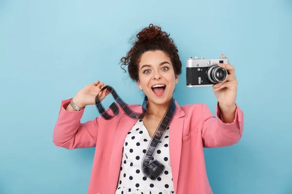 Image of woman with footage over neck taking photo on retro camera — 스톡 사진