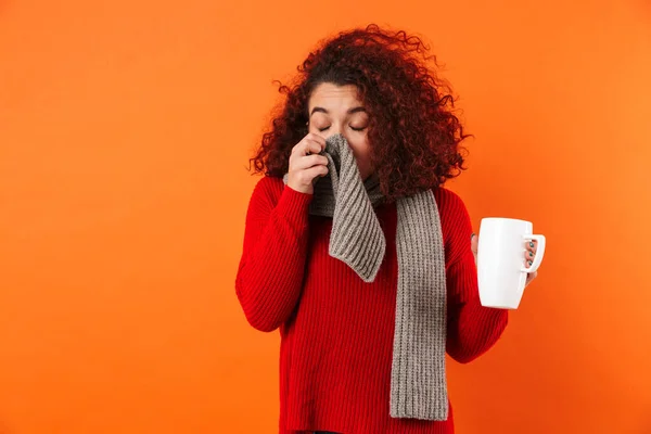 Sick young sneeze woman holding cup of hot tea wearing scarf. — 스톡 사진