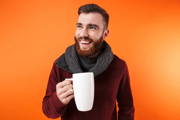 Happy man holding cup of hot tea wearing scarf. — 스톡 사진