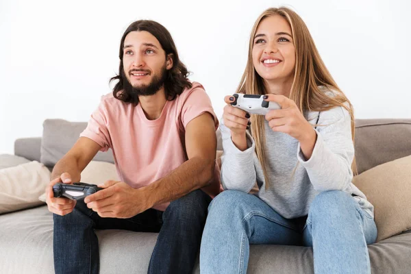 Emotional young loving couple play video games