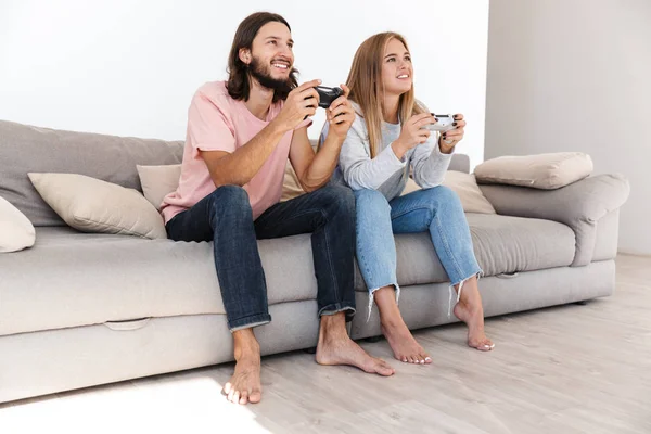 Emotional young loving couple play video games