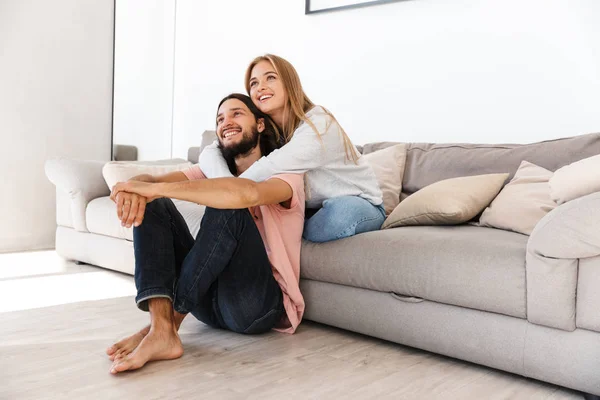 Loving couple on sofa watch tv film