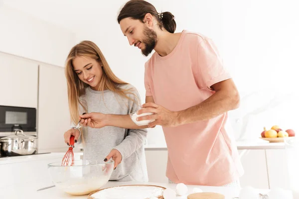 Young loving couple at the kitchen indoors at home — Stock Photo, Image