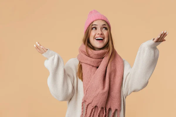 Image of girl wearing winter hat looking upward with arms wide o — Stock Photo, Image