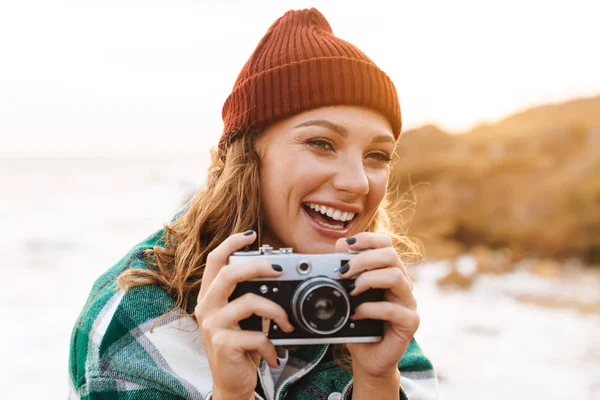 stock image Image of young woman taking photo on retro camera while walking 