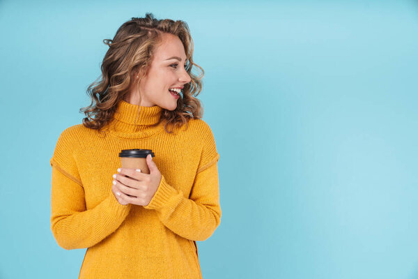 Cheerful lovely young girl wearing sweater standing