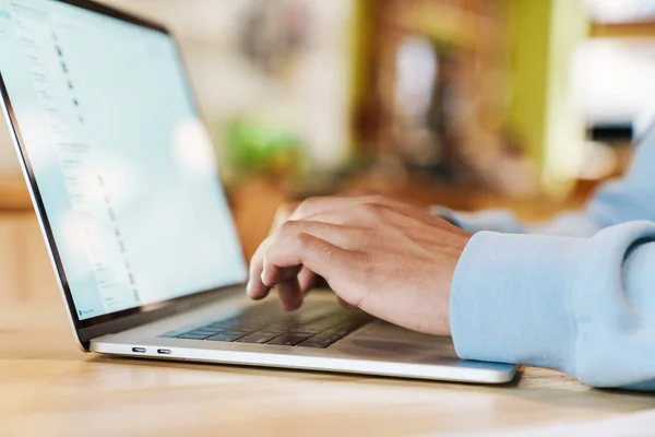 Close up of a businessman working on laptop computer indoors — Stock Photo, Image