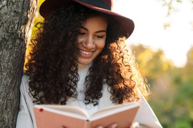 Beautiful smiling african woman wearing autumn coat