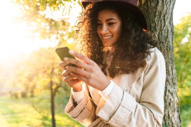 Beautiful smiling african woman wearing autumn coat