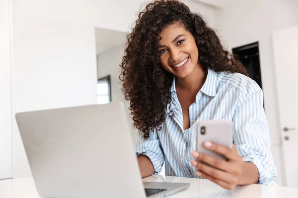 Attraktive junge Afrikanerin arbeitet am Laptop — Stockfoto